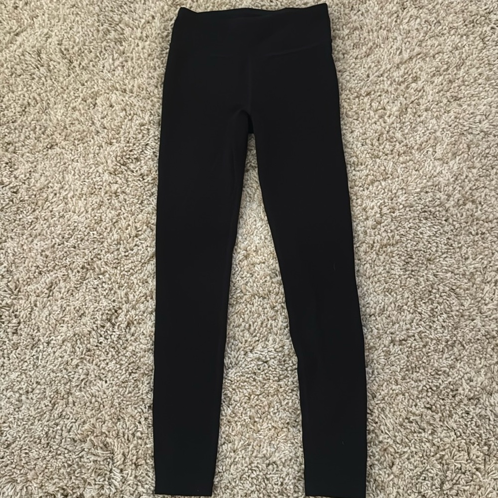 Athletic girl, black leggings, size medium, 8 to 10